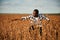 Quality control of wheat. Beautiful African American man is in the agricultural field