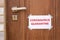 Quarantine warning sign on closed door