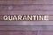 Quarantine - word made from wooden letters, not wooden background. Isolation to prevent infection. Quarantine concept