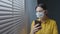 Quarantined woman with face mask using her phone