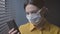Quarantined woman with face mask using her phone