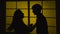 Quarrel in couple. Woman shakes a man. Silhouette. Slow motion. Close up