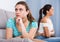 Quarreled girls apart on couch