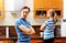 Quarreling couple standing in kitchen and don\'t talking with each other