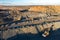 Quarry extracting iron ore with heavy trucks excavators diggers and locomotives aerial view.