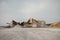 Quarry machines and piles of gravel over blue sky. Stone crushing and screening plant