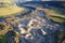 Quarry works industrial digging aerial view from above showing sand mound and hills