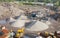 Quarry works industrial digging aerial view from above showing sand mound and hills