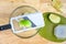 Quartered granny smith apple, green cutting board, and mandolin slicer on a butcher block table