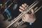 Quartet of brass instruments - Brass instruments - Close-up of hands - slight desaturation