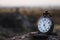 Quartz pocket analog watch kept on a rock