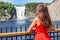 Quebec city sightseeing tourist woman at Chute montmorency falls quebec popular attraction. Young lady in red summer