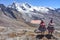 Quechua girls admire Andean mountain views on the Ausangate trail. Cusco, Peru