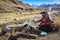 A Quechua lady dyeing Alpaca Wool for textile making. Chillca, Cusco, Peru