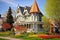 a queen anne home with a widows walk and turret