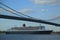 Queen Mary 2 cruise ship in New York Harbor under Verrazano Bridge heading for Transatlantic Crossing from New York to Southampton