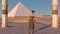 Queen Nefertiti in front of the great pyramid of Giza and a view of the desert in the ancient temple. Historical animation. The