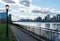 Queensbridge Park with a Street Light along the East River with the Manhattan Skyline in New York City