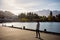 Queenstown, New Zealand, October 6, 2019: Beautiful image of a boy watching the orange sunrise among the snowy mountains