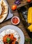 Quesadilla, salad with cottage cheese and tomatoes, two corn on wood table.