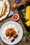 Quesadilla, salad with cottage cheese and tomatoes, two corn on wood table.