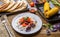 Quesadilla, salad with cottage cheese and tomatoes, two corn on wood table.