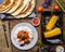 Quesadilla, salad with cottage cheese and tomatoes, two corn on wood table.