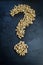 Question mark drawn by wood pellets, concept to illustrate the unknown of the price increase also of alternative energy materials