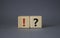 Question mark and exclamation mark symbol. Question mark and exclamation mark on wooden cubes. Beautiful grey background. Business