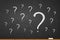 Question mark. Faq on chalkboard. Answer on ask. Many questions written chalk on blackboard. Background with concept why,  problem