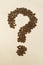Question mark image made up of coffee beans.