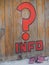 Question mark and info word on wooden wall