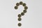 Question mark made of euro coins on white background - Concept of financial uncertainty, crisis and uncertain future of euro