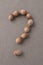 A question mark made of hazelnut. The concept of frequently asked questions
