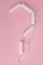 Question mark made from hygienic tampons on a pink background. Vertical Orientation