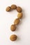 a question mark made of walnuts. The concept of frequently asked questions