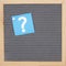 Question mark message on sticky note on gray felt letter board