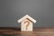 Question mark on a wooden house. Solving housing problems, deciding to buy or rent real estate. Search for options