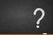 Question mark written chalk on blackboard. Faq concept. Ask question. Finding an answer to question. Queries handwritten on chalkb