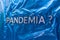 The question pandemia translation from spanish - pandemic laid with silver letters on crumpled blue plastic film