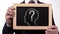 Questionmark head image on blackboard in businessman hands, searching solution