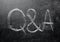 Questions and answers on a black chalkboard