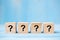 Questions Mark  ?  word with wooden cube block on blue table background. FAQ frequency asked questions, Answer, Q&A,