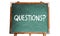 Questions? text word message in white chalk written on a green old grungy vintage wooden chalkboard or blackboard with frame