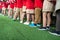 Queue of Asian kids in school uniform standing in line