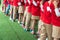 Queue of Asian kids in school uniform standing in line