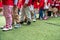 Queue of Asian kids in school uniform standing in line