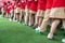 Queue of Asian kids in school uniform standing in line