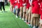 Queue of Asian kids in school uniform standing in line