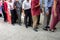 Queue of Asian people wait in line in urban street